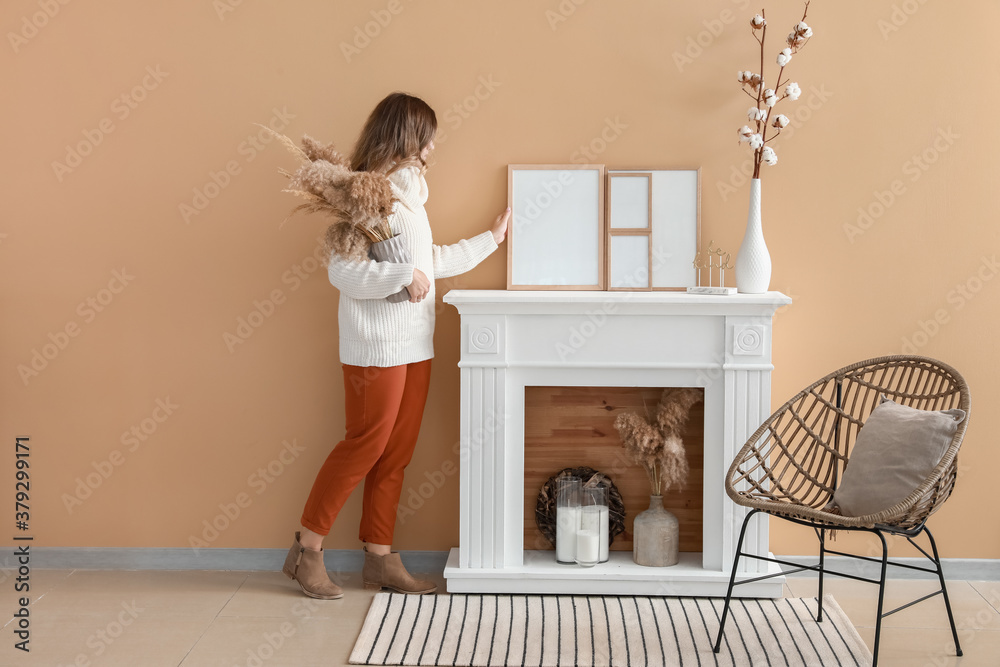 Woman decorating room with photo frames