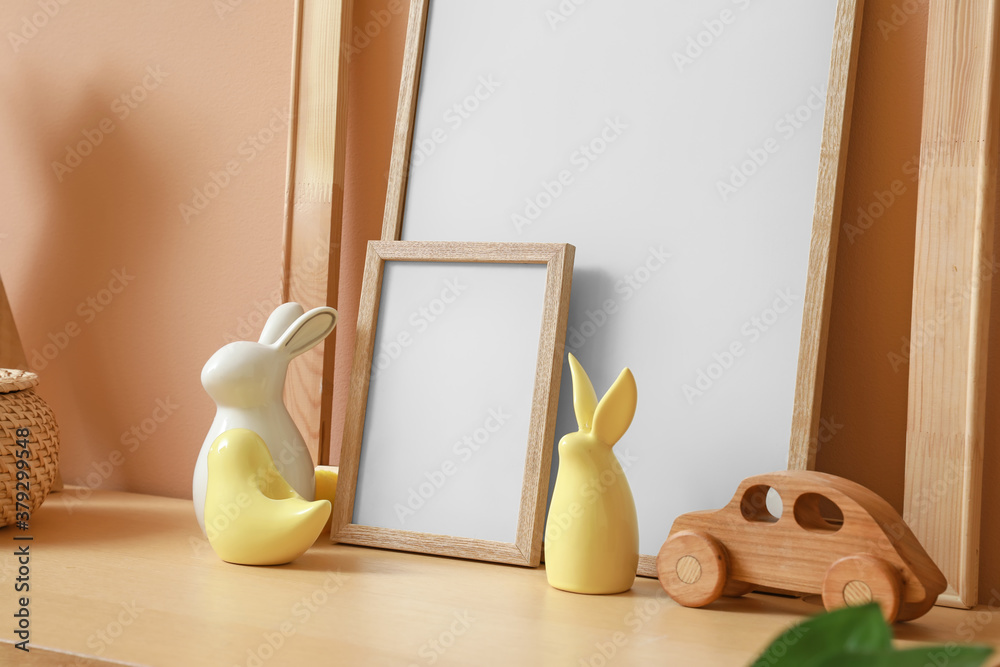 Table with blank frames and decor in room