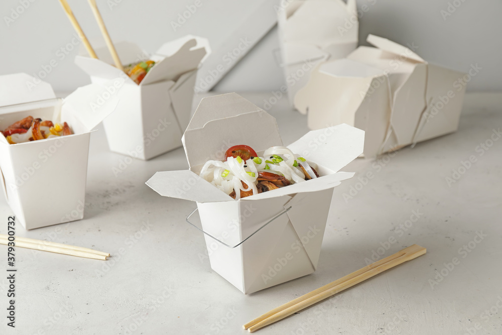 Boxes with with tasty rice noodles on white background