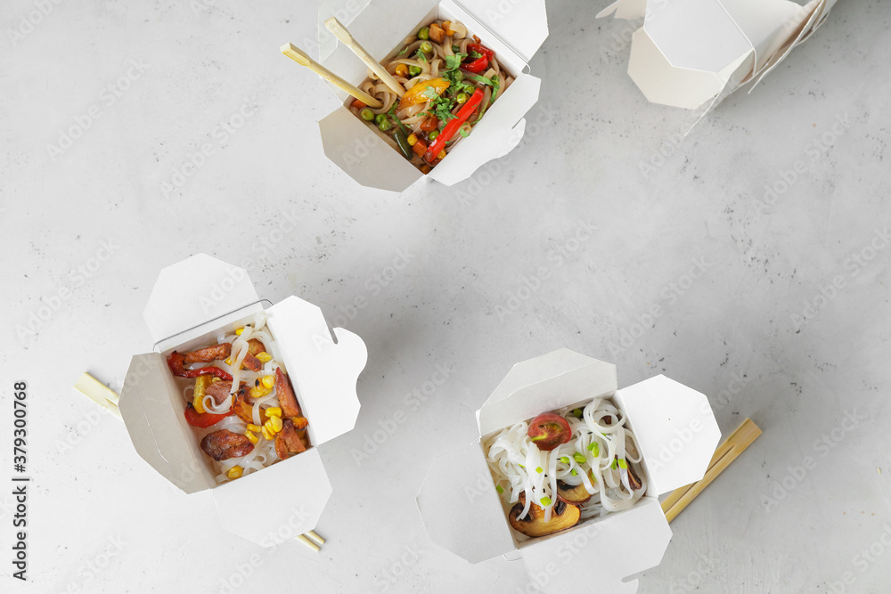 Boxes with with tasty rice noodles on white background