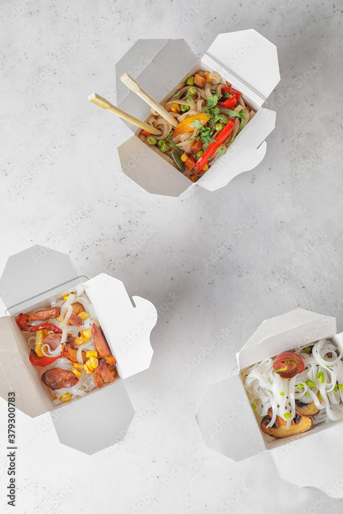 Boxes with with tasty rice noodles on white background