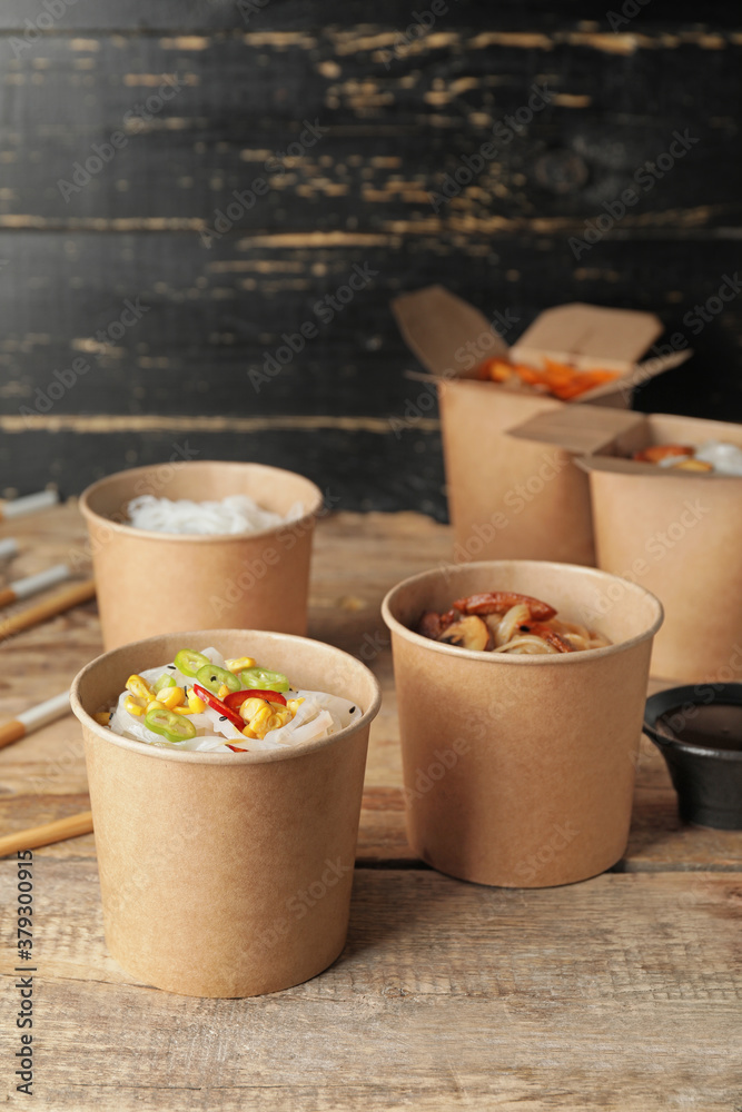 Bowls with tasty rice noodles on table