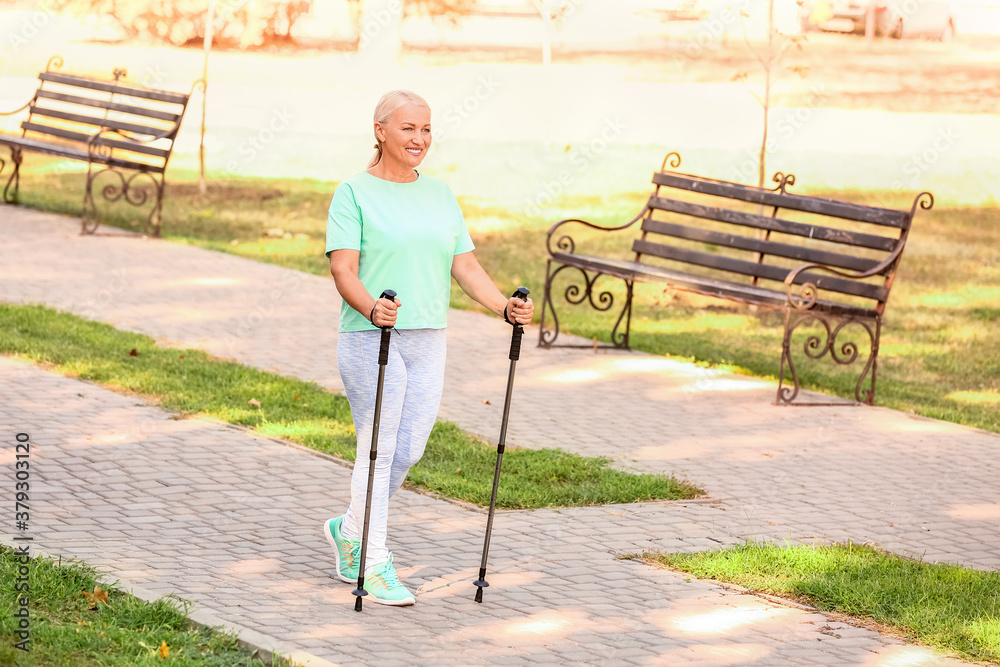 Mature woman with walking poles outdoors