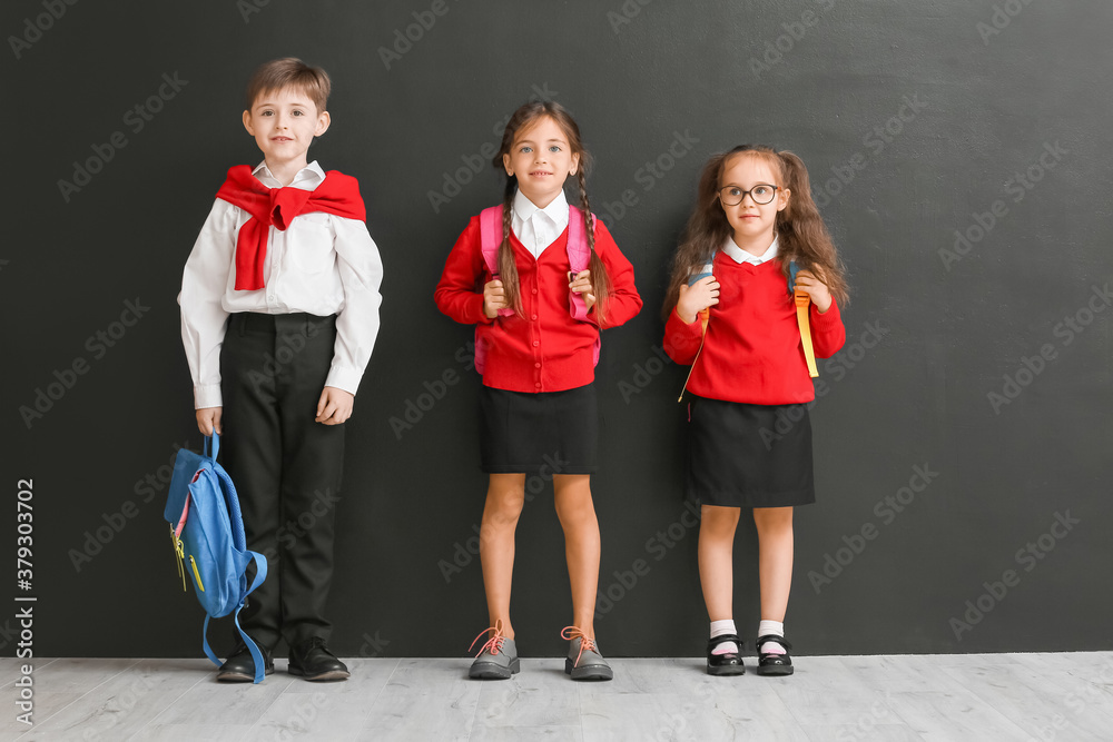 Little pupils near dark wall