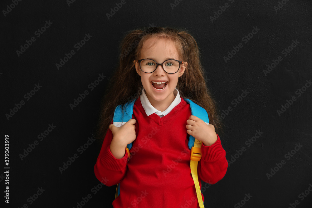 Little schoolgirl on dark background