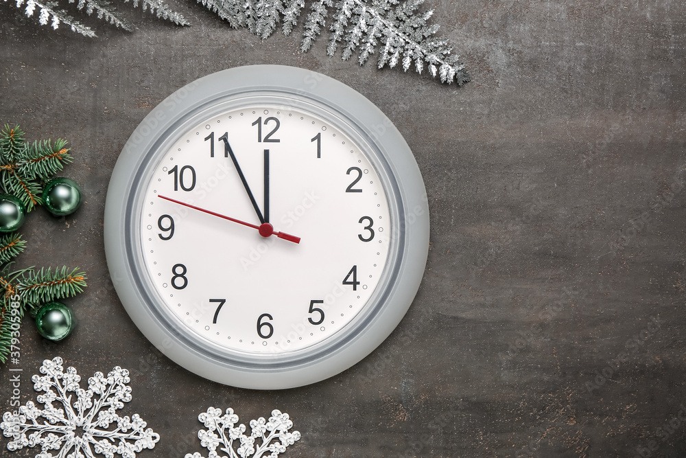 Clock and Christmas decor on grey background