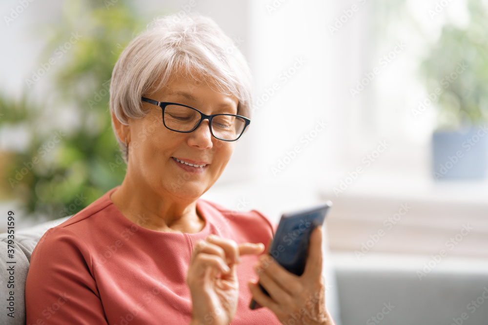 senior woman is using smartphone