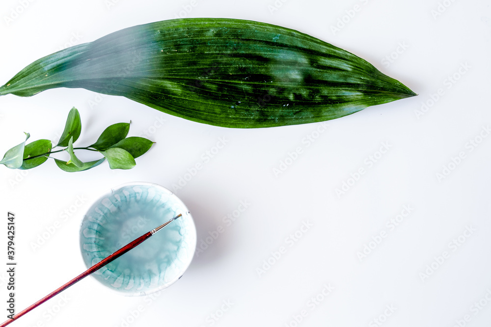 painted ceramic cup on white background top view