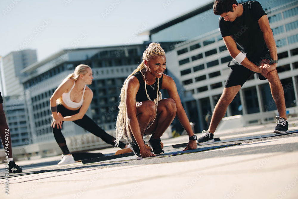 Group of friends exercising together in the city