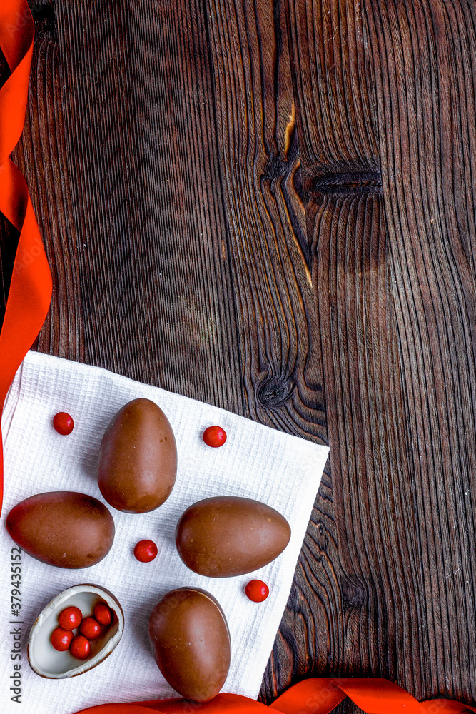 Easter chocolate eggs top view on wooden background mock up