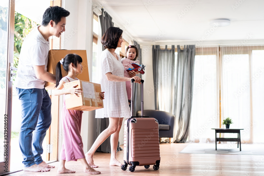 Asian big family moving packing boxes and cloth baggage to new house.