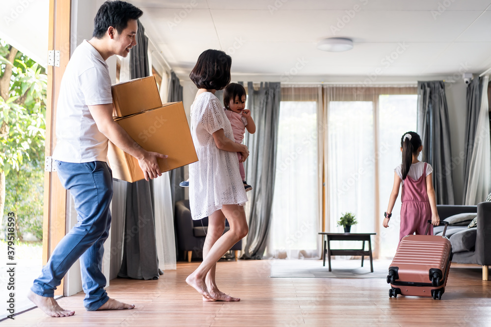 Asian big family moving packing boxes and cloth baggage to new house.