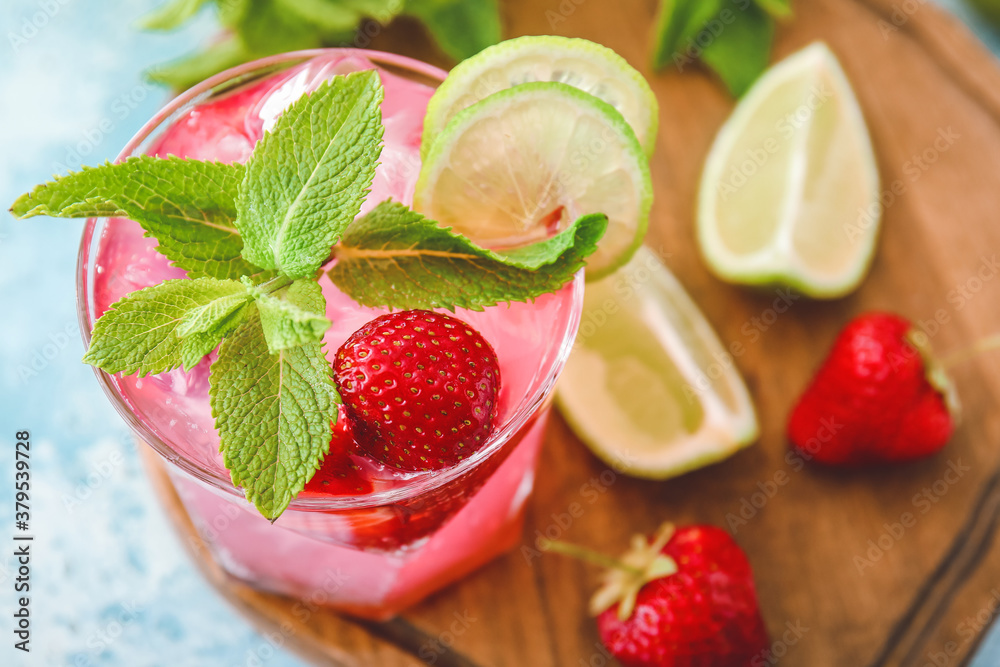 Glass of fresh strawberry mojito on table