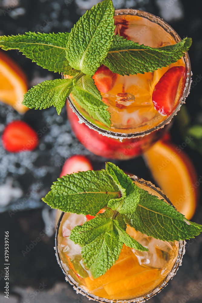 Glasses of fresh strawberry mojito on dark background, closeup