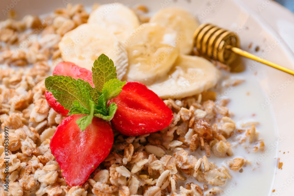 Bowl with tasty sweet oatmeal, closeup