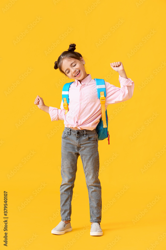 Little schoolgirl on color background