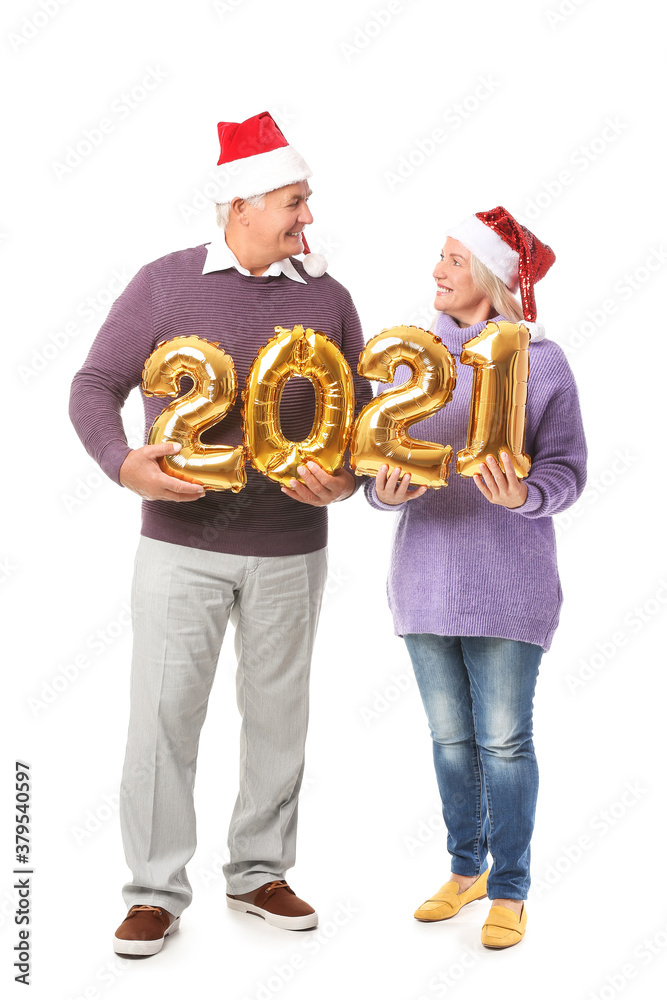 Elderly couple with balloons in shape of figure 2021 on white background. New Year celebration