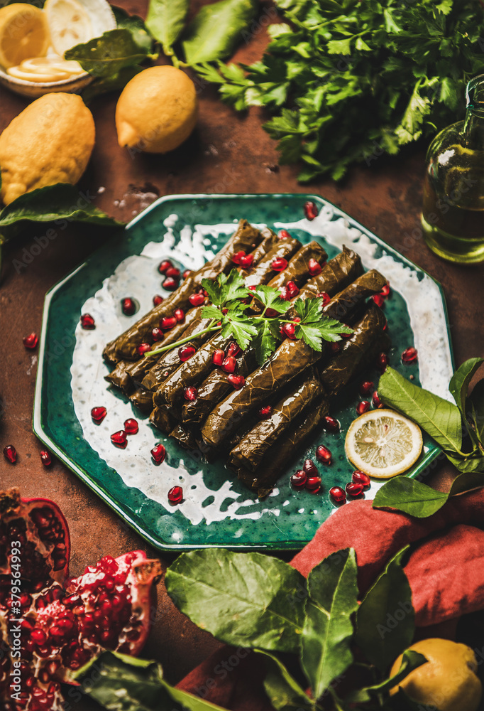 Turkish traditional starter meze. Sarma wine leaves filled with rice, spices with pomegranate, olive