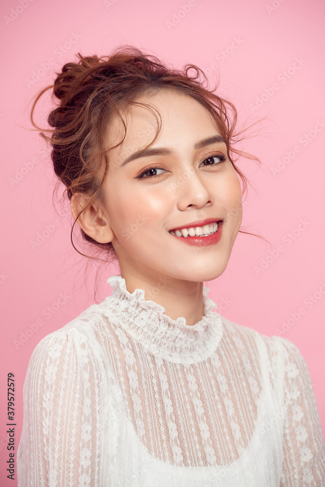 Beauty cute fashion model with natural make up on pink background