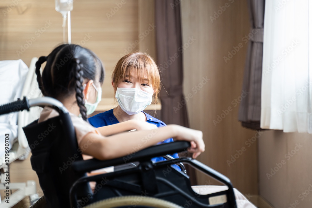 Asian nurse serves medical care service to kid patient on wheelchair