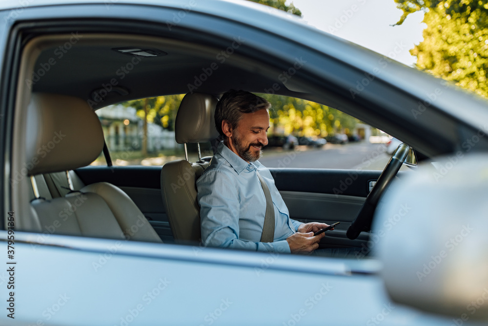 Man in a car, business person.