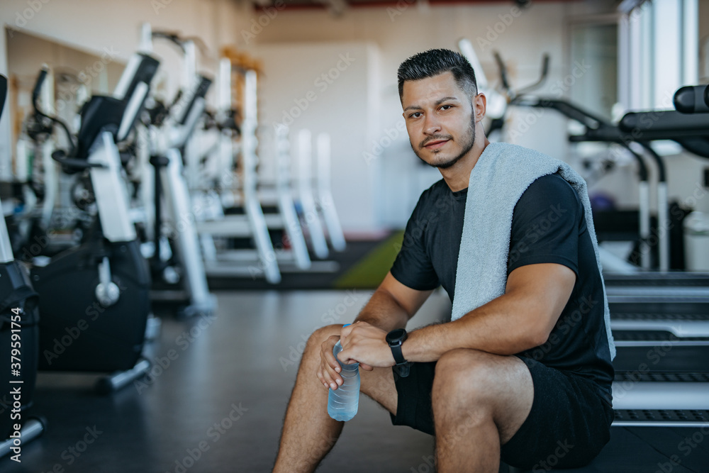 Muscular man at gym, rest.