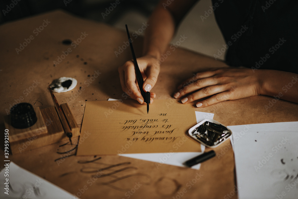 Handwriting a letter on parchment, close-up.