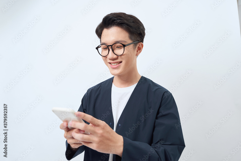 Young handsome asian man using mobile phone