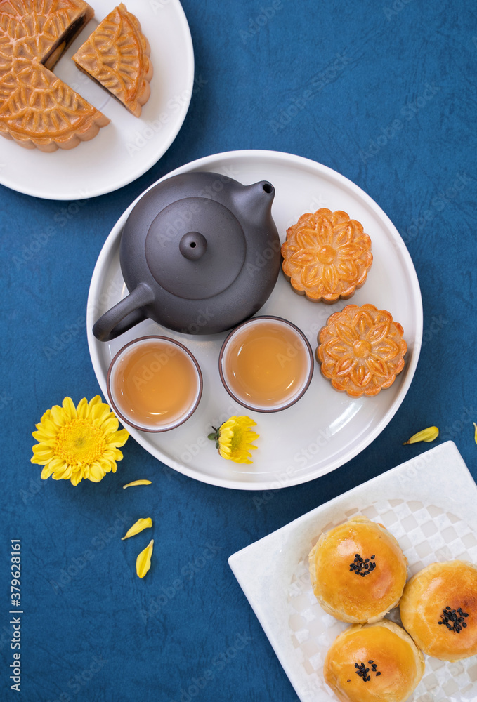 Moon cake for Mid-Autumn Festival, delicious beautiful fresh mooncake on a plate over blue backgroun