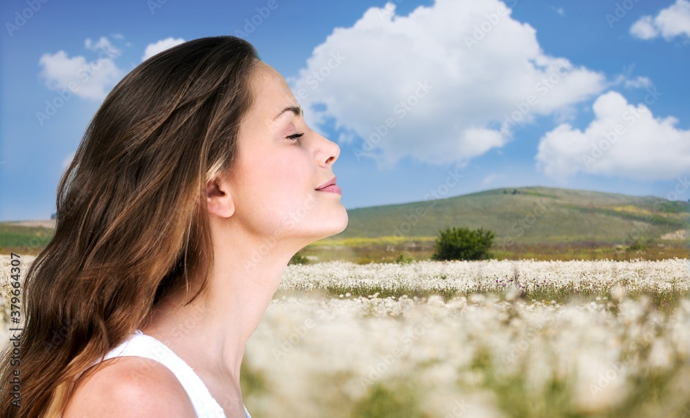 Happy young woman with perfect skin on outdoor background