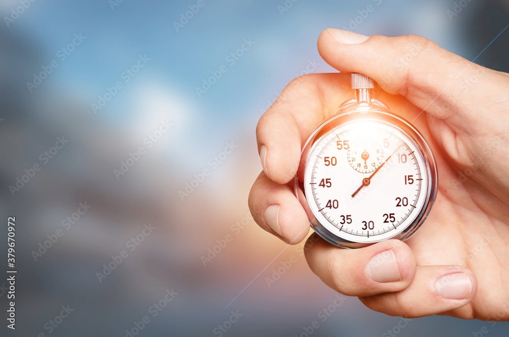 Silver classic stopwatch in human hand