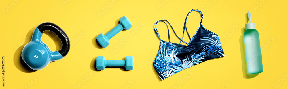 Fitness theme with dumbbells and a sportswear - flat lay