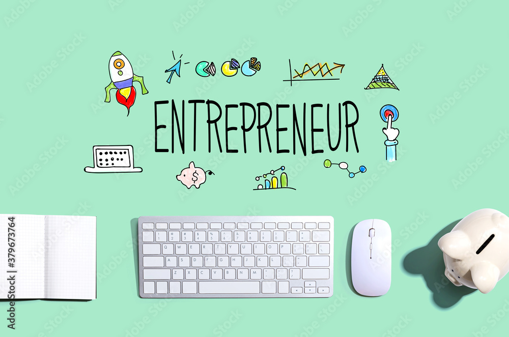 Entrepreneur with a computer keyboard and a piggy bank