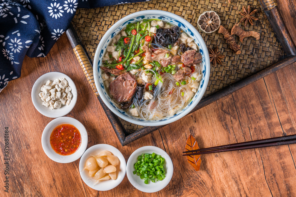 A bowl of Shaanxi Xian delicious mutton steamed bun on a wooden table