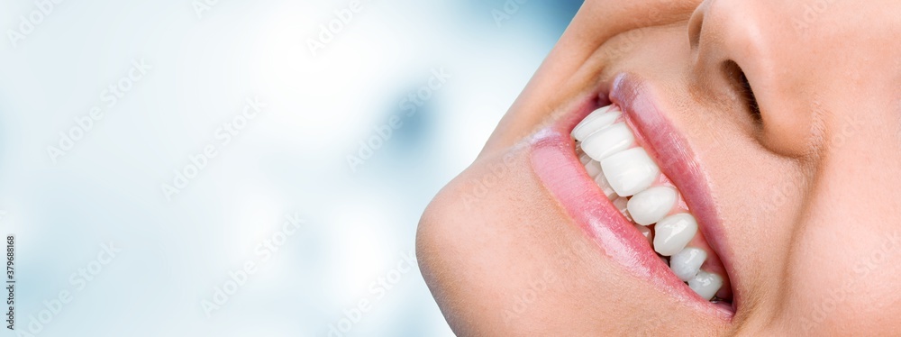 Beautiful smile of young woman with healthy white teeth