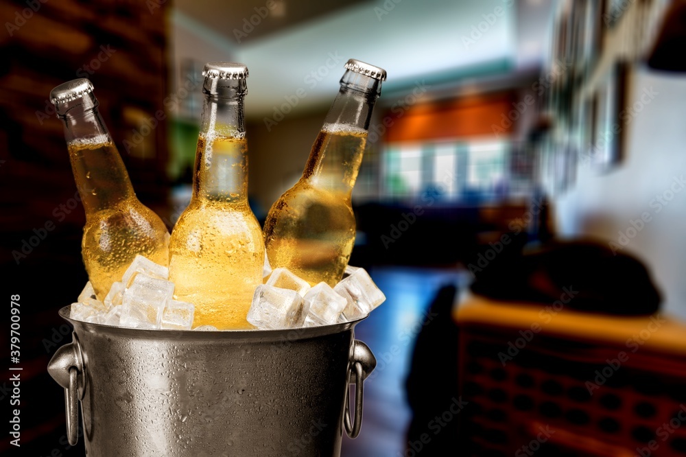 Bottles of cold and fresh beer with ice in the bucket