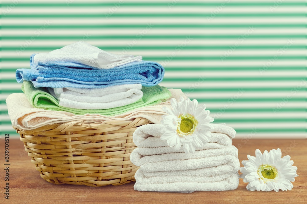 Laundry basket with colorful towels on desk