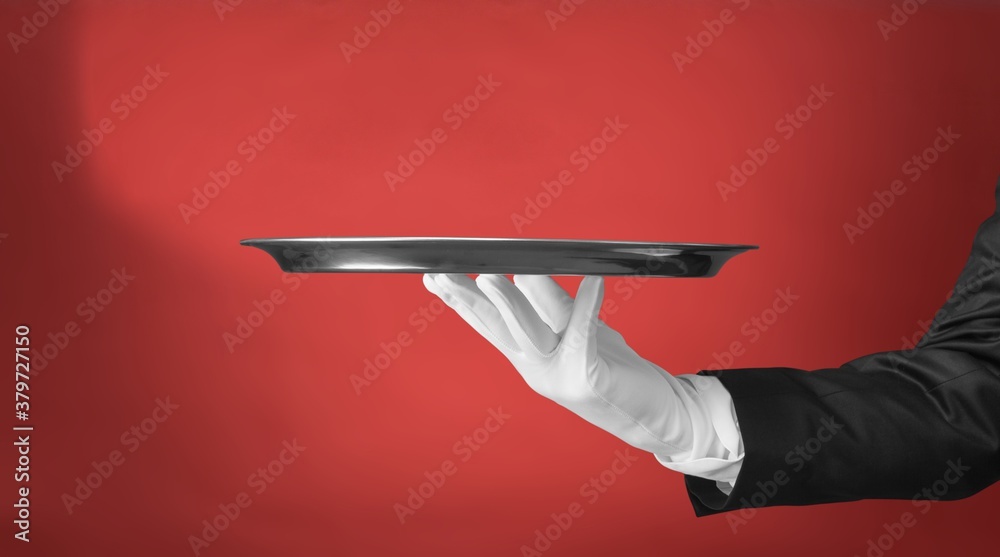 Elegant waiter hand in white glove holding an empty plate