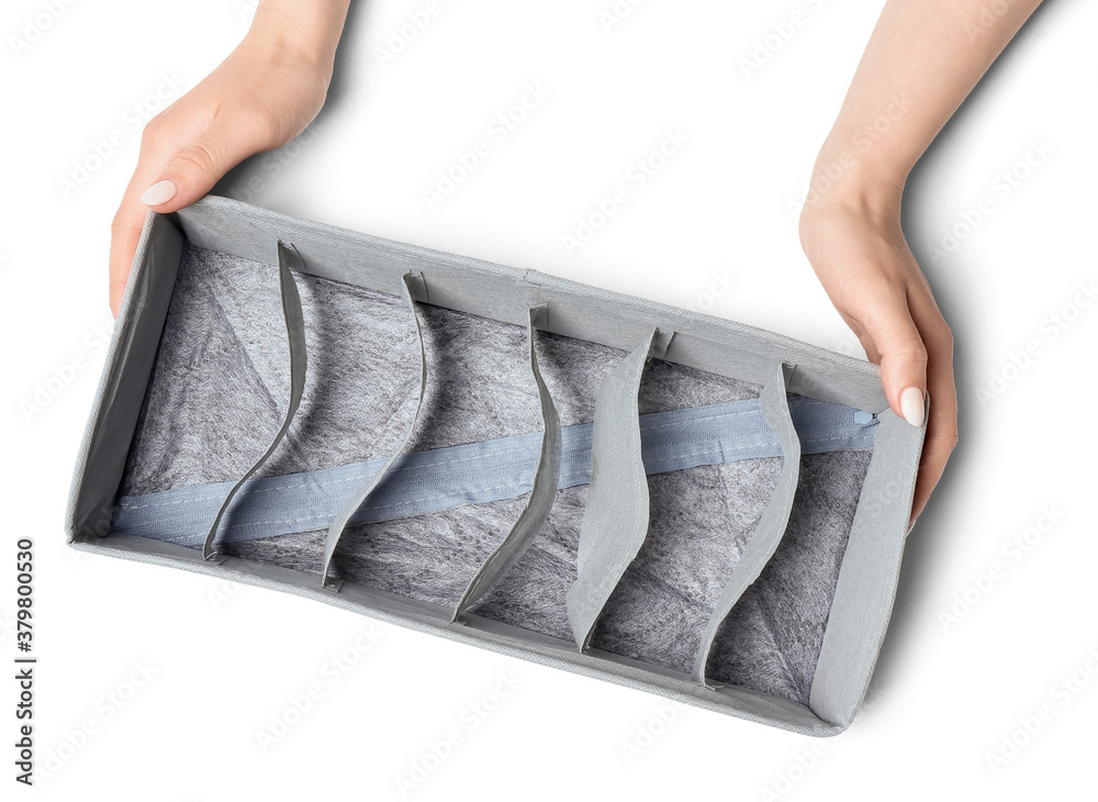 Female hands with empty organizer for clean clothes on white background