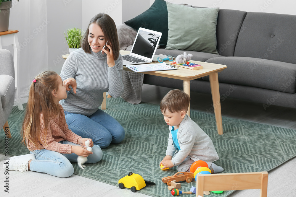 Working mother with little children at home