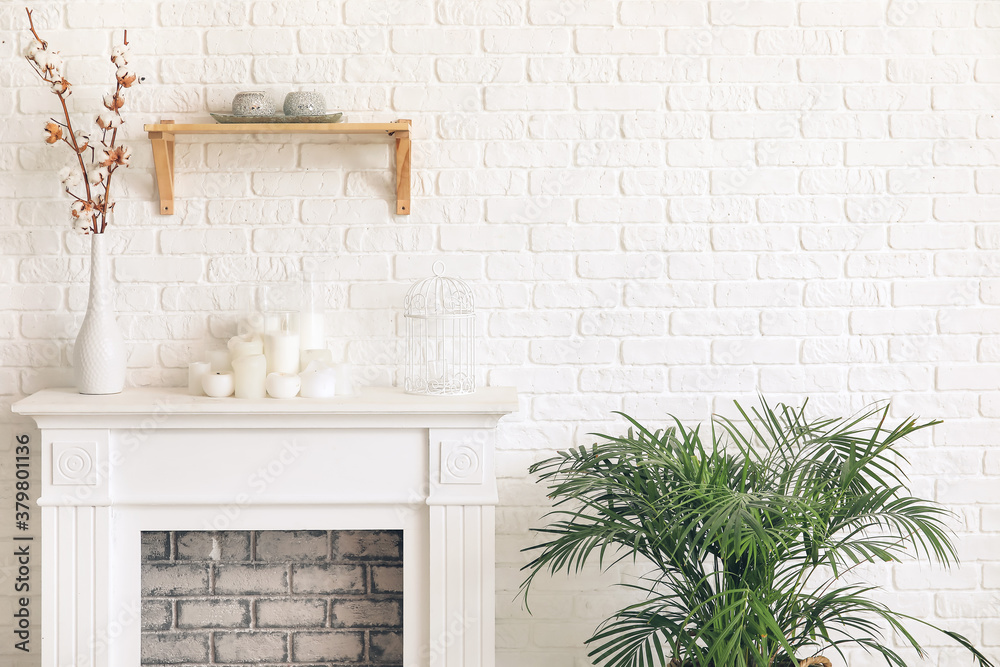 Modern fireplace near wall in room