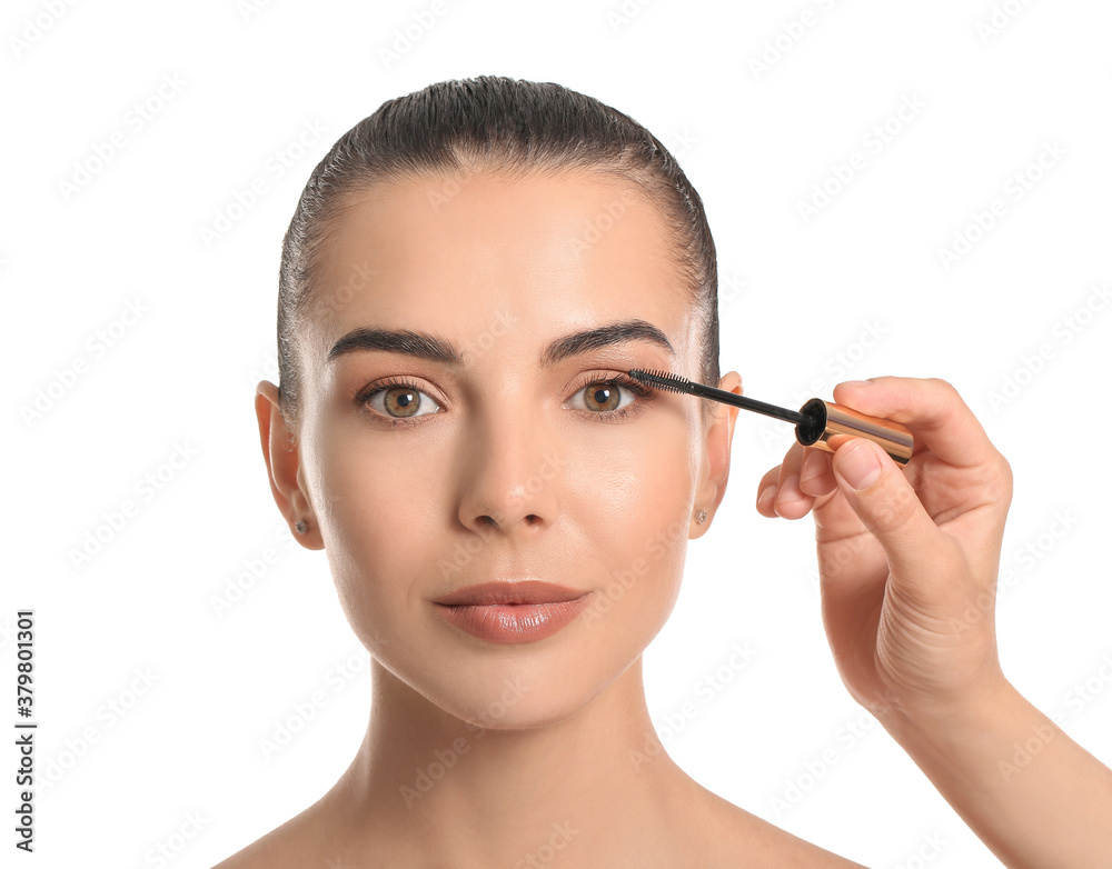 Makeup artist working with beautiful young woman on white background