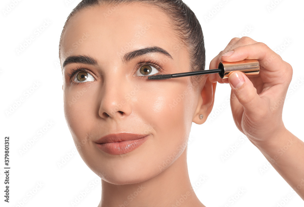 Makeup artist working with beautiful young woman on white background