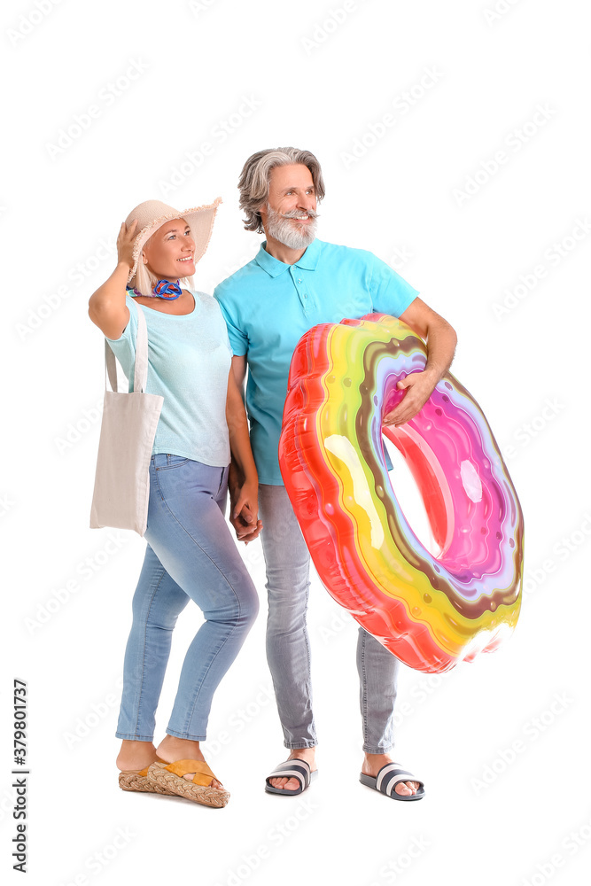 Mature couple with inflatable ring on white background