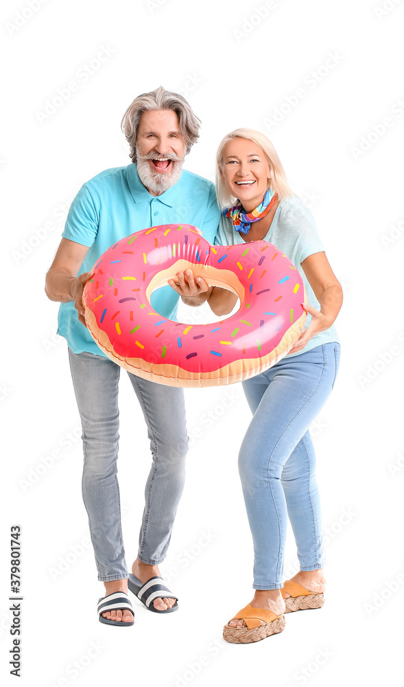 Mature couple with inflatable ring on white background