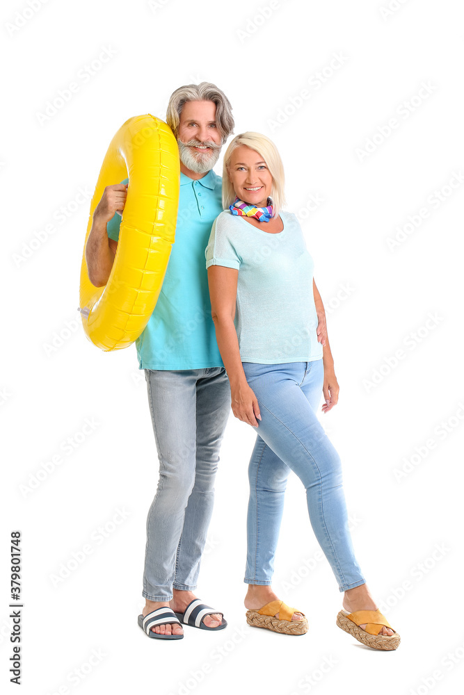 Mature couple with inflatable ring on white background