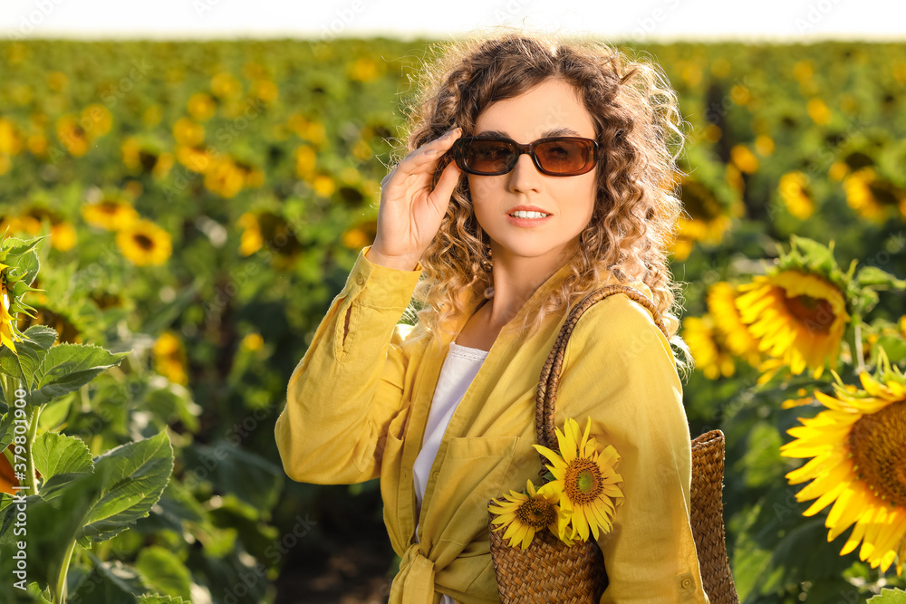 Beautiful young woman in sunflower field