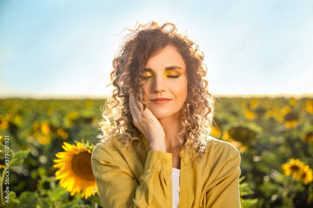 Beautiful young woman in sunflower field