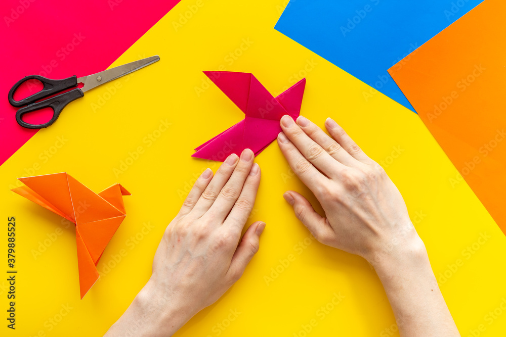 DIY concept. Doing origami paper bird, Top view