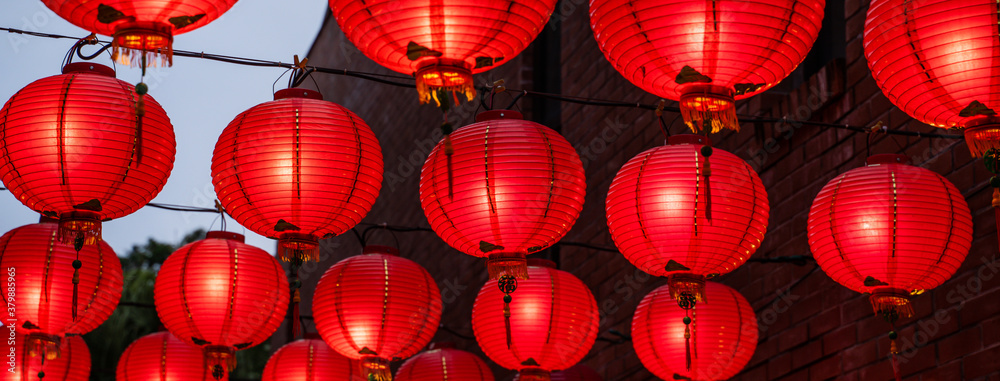 Beautiful round red lantern hanging on old traditional street, concept of Chinese lunar new year fes